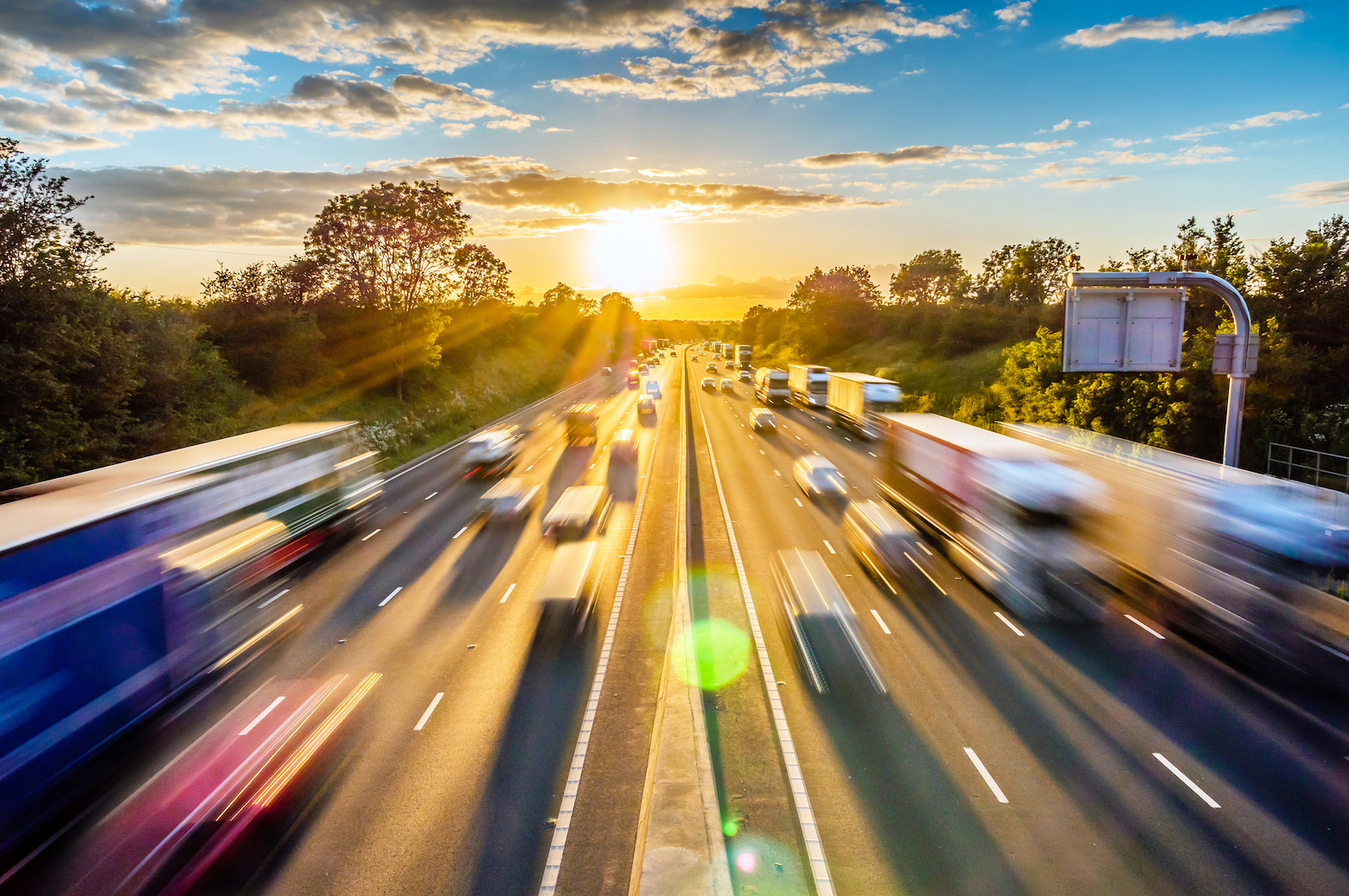 heavy traffic moving at speed on UK motorway in England at sunset - logistics